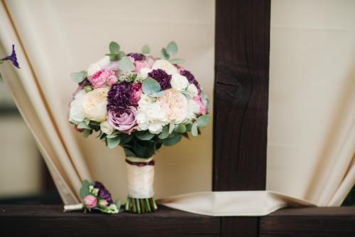 wedding bouquet with roses and boutonniere.The decor at the wedding