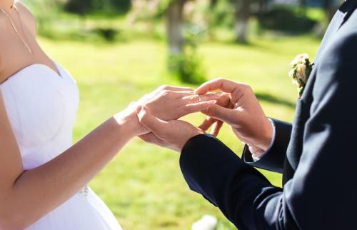 Wedding engagement rings. Married couple exchange wedding rings at a wedding ceremony.